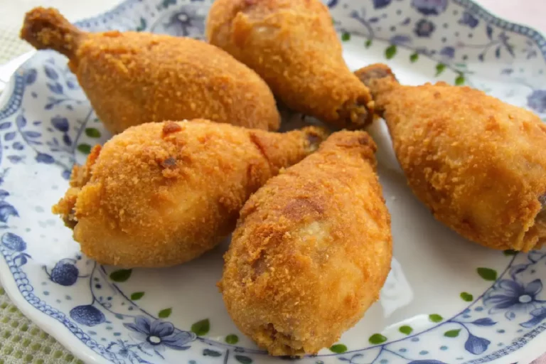 Coxa de frango ao forno coberta com creme cremoso e gratinada com queijo.